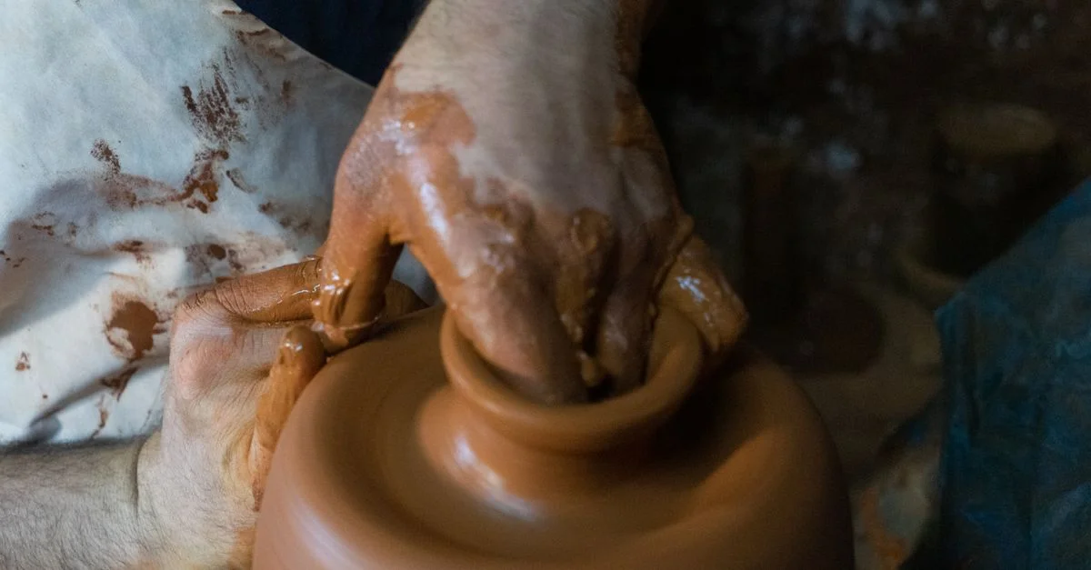 Les mains du potier façonnent habilement l'argile sur un tour de potier, mettant en valeur le savoir-faire et la créativité.